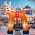 Tall reindeer arch inflatable standing over a snowy front path to a house