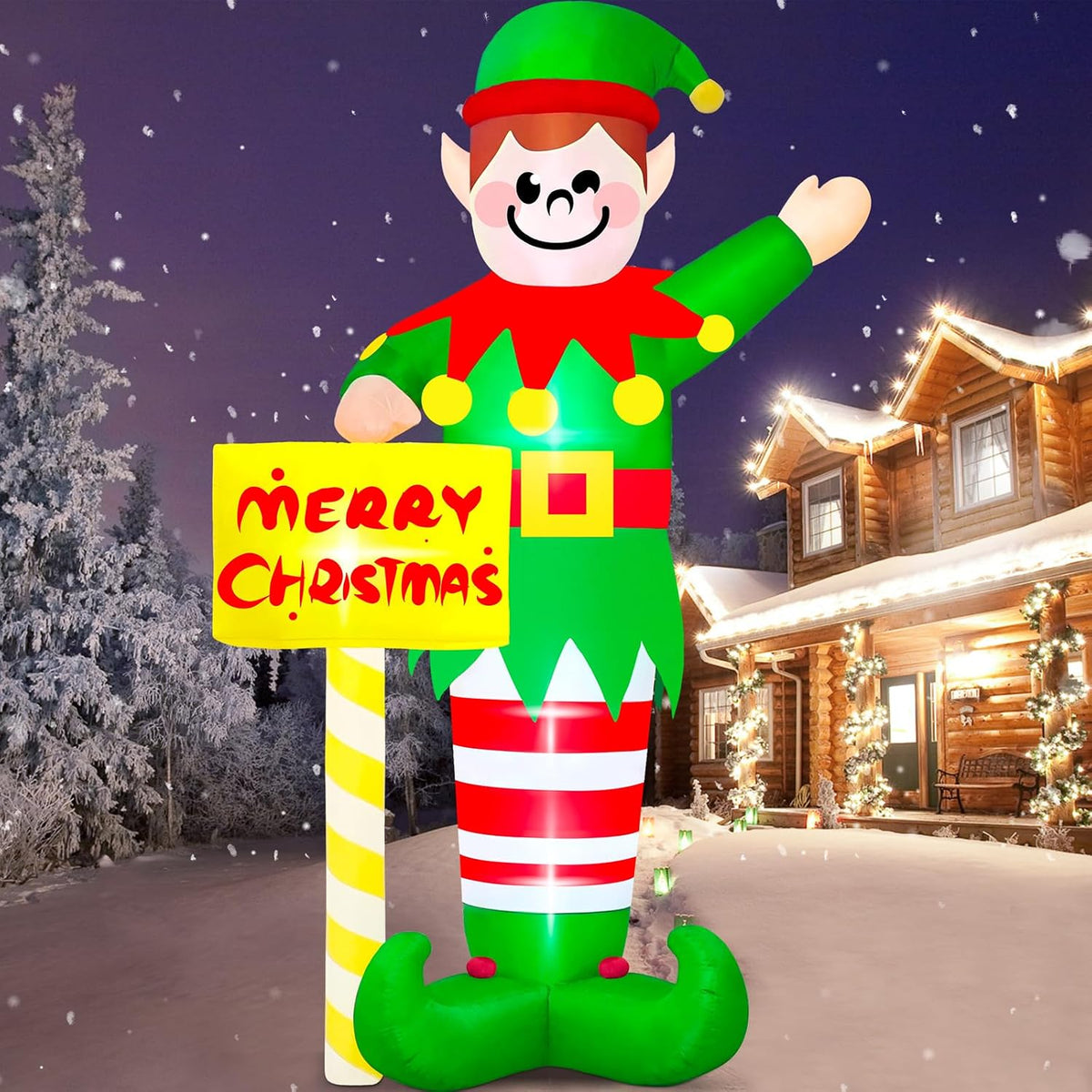 Giant elf inflatable waving beside a Merry Christmas street sign in a snowy yard