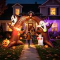 Haunted tree arch inflatable with ghosts over a front path, a woman and child walking through