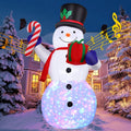 Snowman inflatable in a top hat holding a candy cane and a gift with a glowing multicolor lower body
