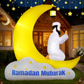 Figure in white praying on a golden crescent moon inflatable over a Ramadan Mubarak cloud at night