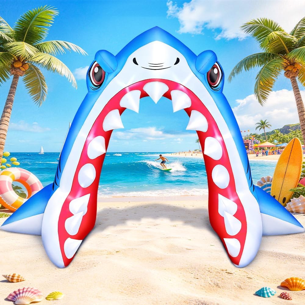 Blue shark inflatable arch with an open toothy mouth on a beach