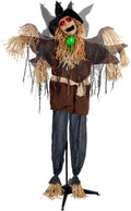 Tall scarecrow prop in a tattered hat and burlap coat on a pole stand