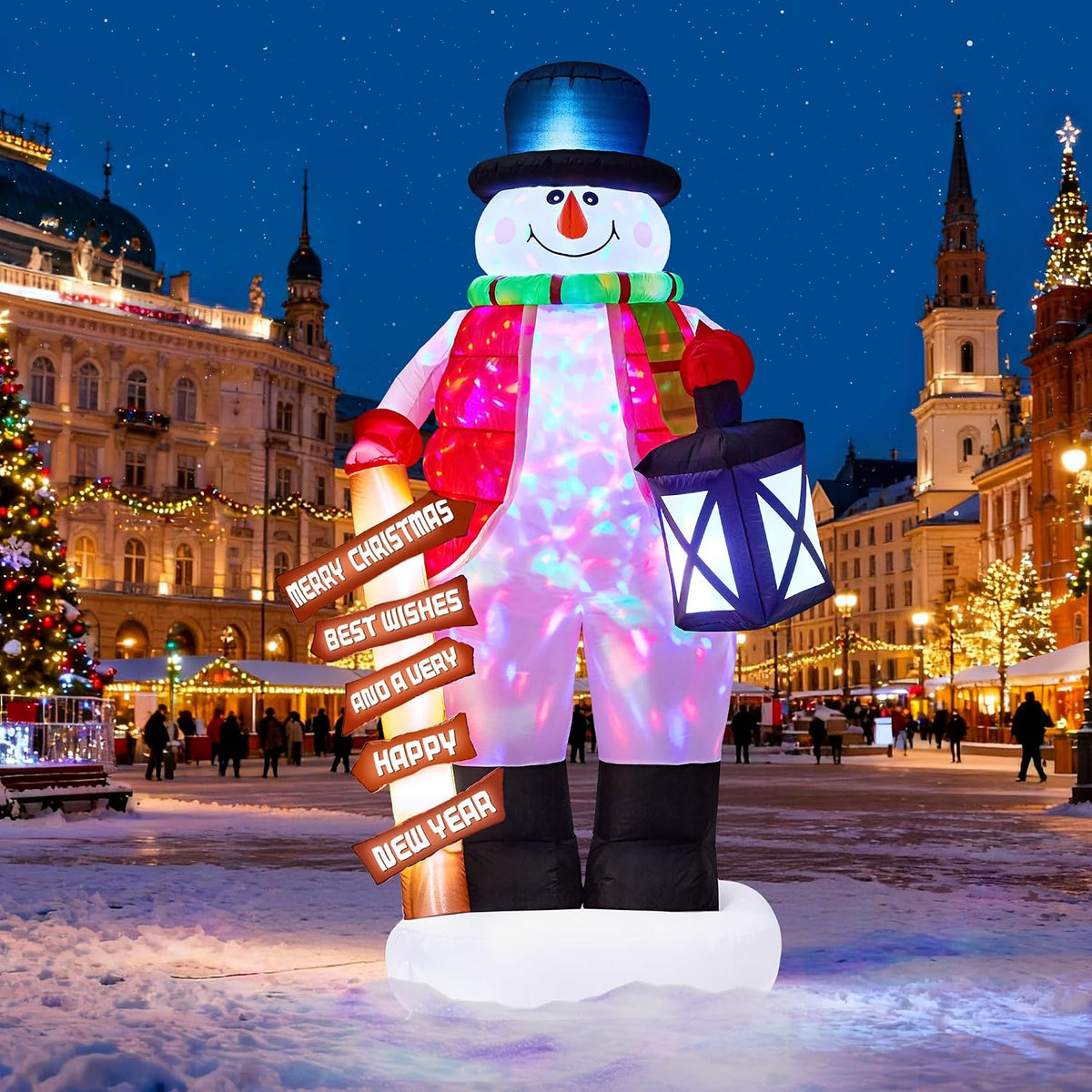 Snowman inflatable in a blue top hat holding a lantern and a Christmas signpost in a town square