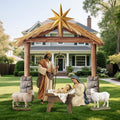 Outdoor nativity set with a wooden stable and gold star, Joseph, Mary, the manger and two sheep on a lawn