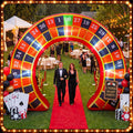 Roulette wheel inflatable arch over a red carpet at an outdoor casino night party