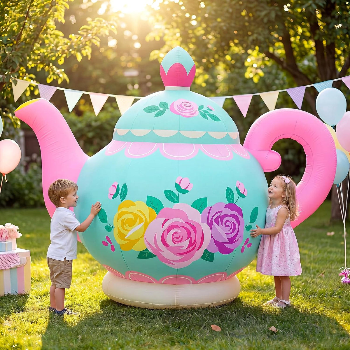 Giant mint teapot inflatable with painted roses and two children beside it at a garden party