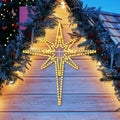 Warm white LED Bethlehem star glowing under evergreen garland
