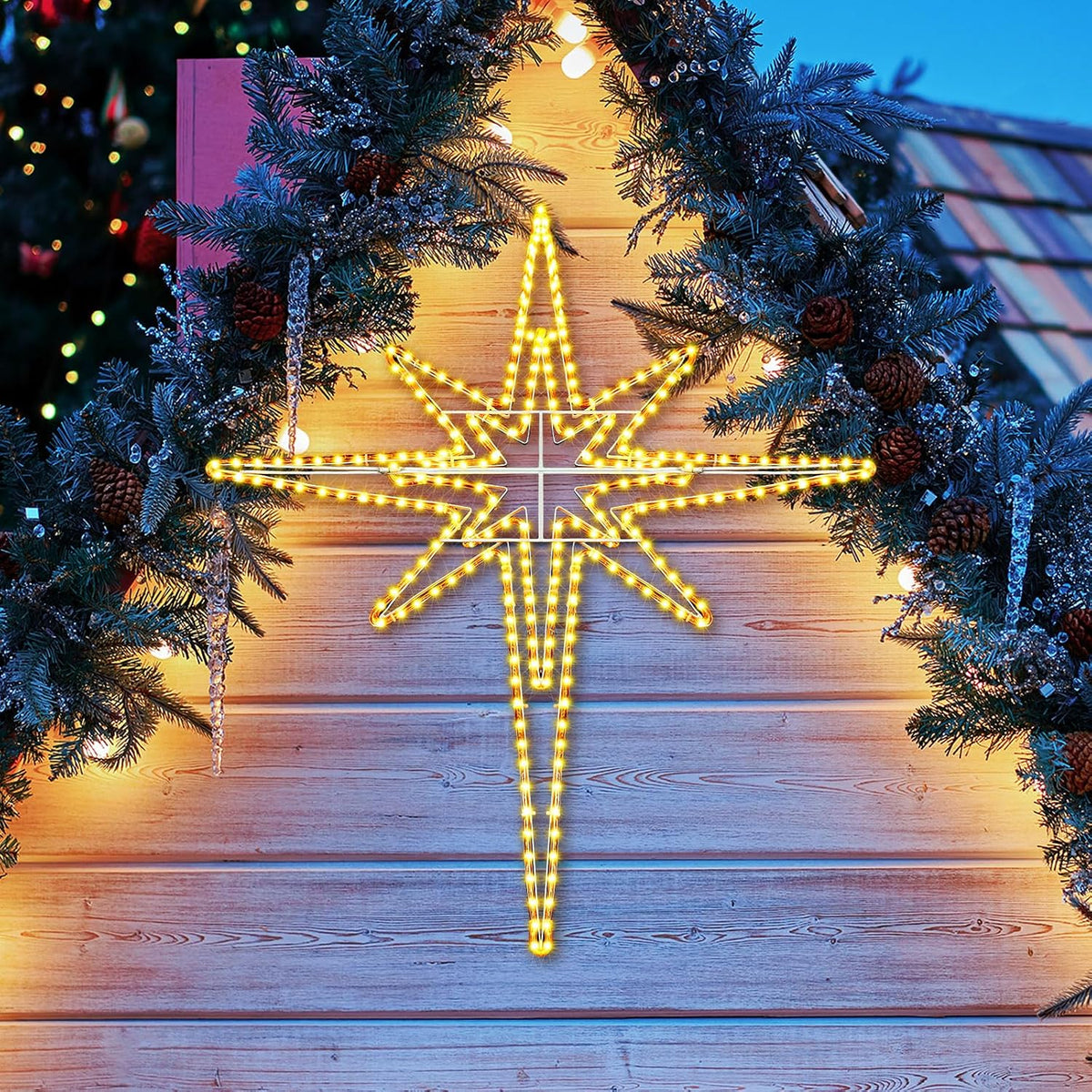 Warm white LED Bethlehem star glowing under evergreen garland